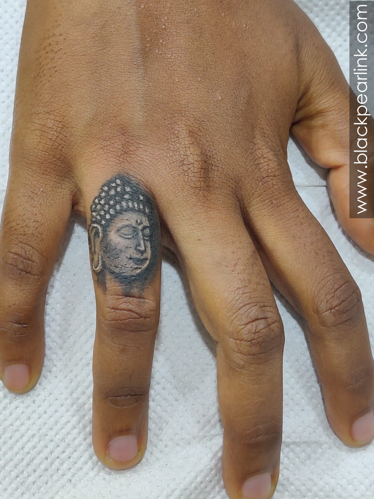 Cute Little Buddha Tattoo on Finger