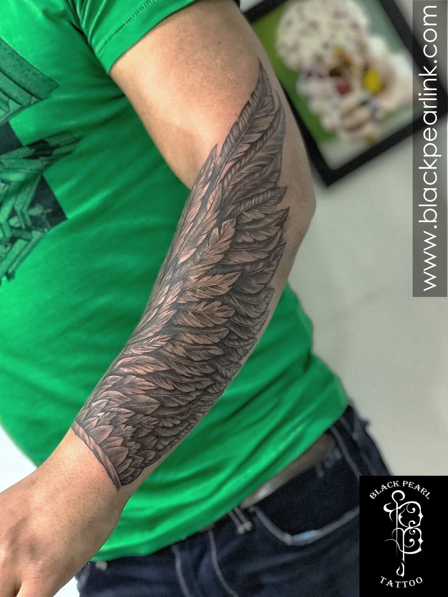 wing tattoo forearm