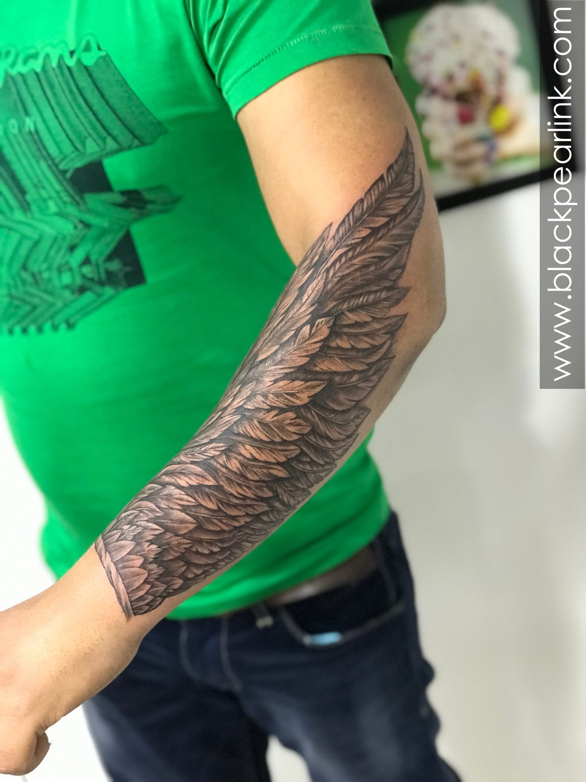 wing tattoo forearm