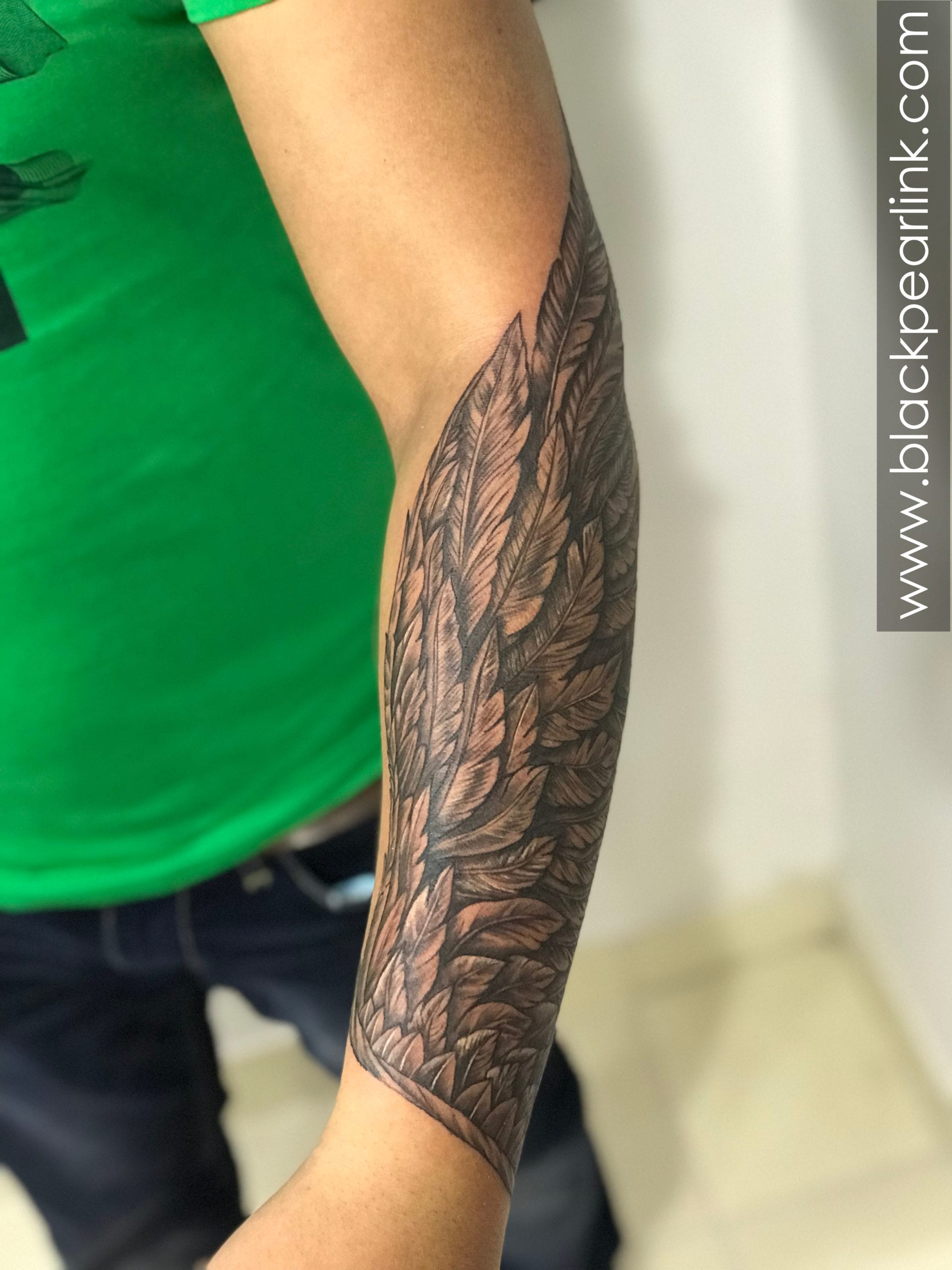 wing tattoo forearm