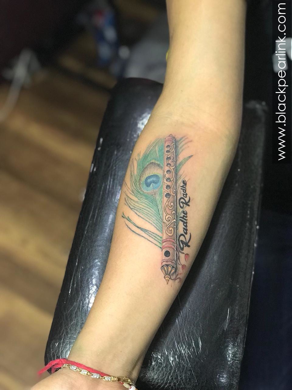 Peacock Feather with flute tattoo | Flute tattoo, Hand tattoos for girls,  Feather tattoo design