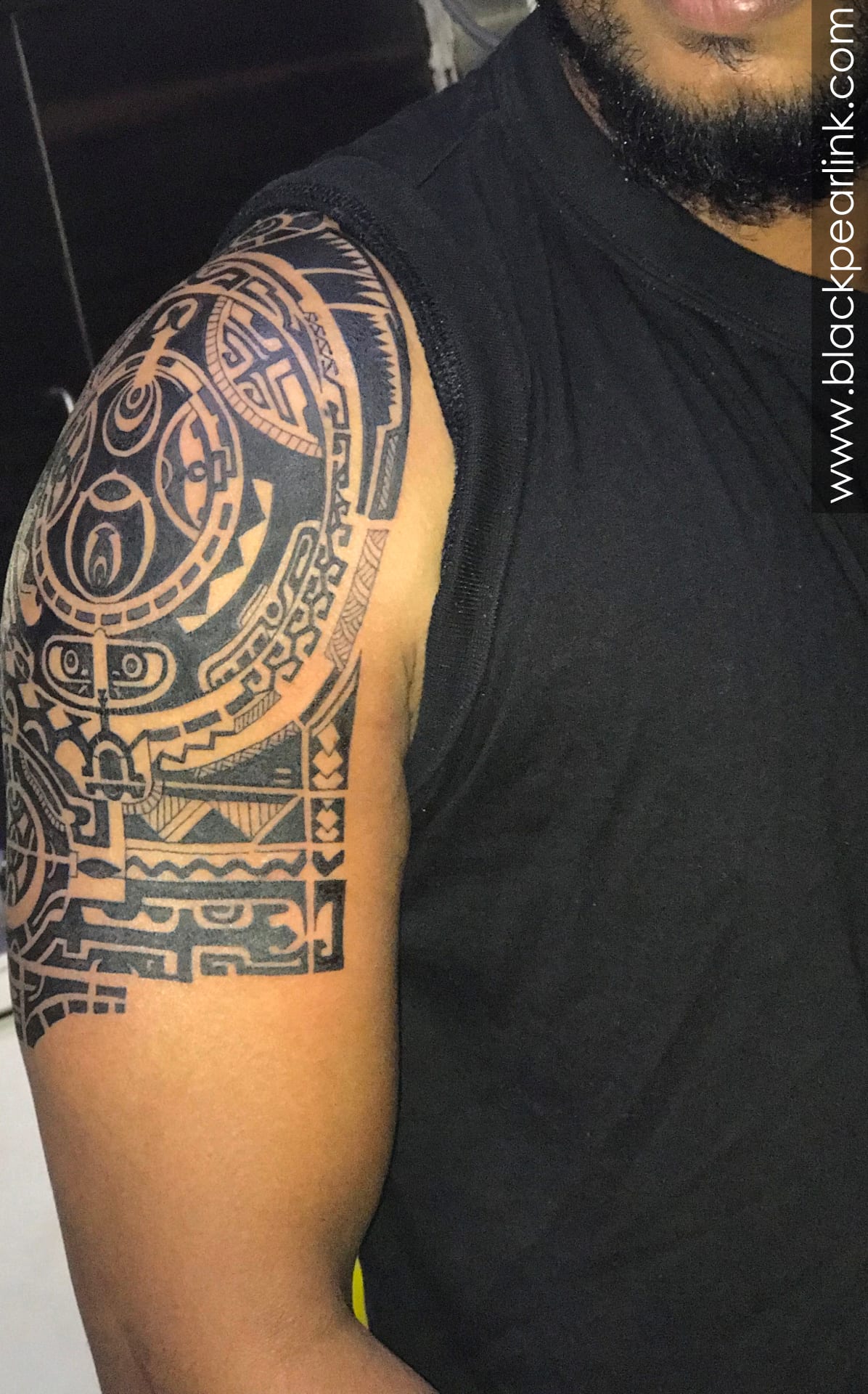 tribal upper arm tattoo